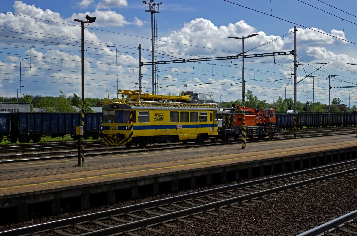Ihre Abstammung von den Schienenbussen der Baureihe 810 k�nnen die Oberleitungs-Baufahrzeuge der Gattung MVTV2 nicht verleugnen. Mit einem auf einen Flachwagen aufgebauten Kran im Schlepptau durchf�hrt MVTV2-060 am 25.04.24 den Bahnhof Ostrava-Svinov.